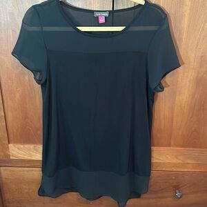 Vince Camuto top in black with sheer bodice area.